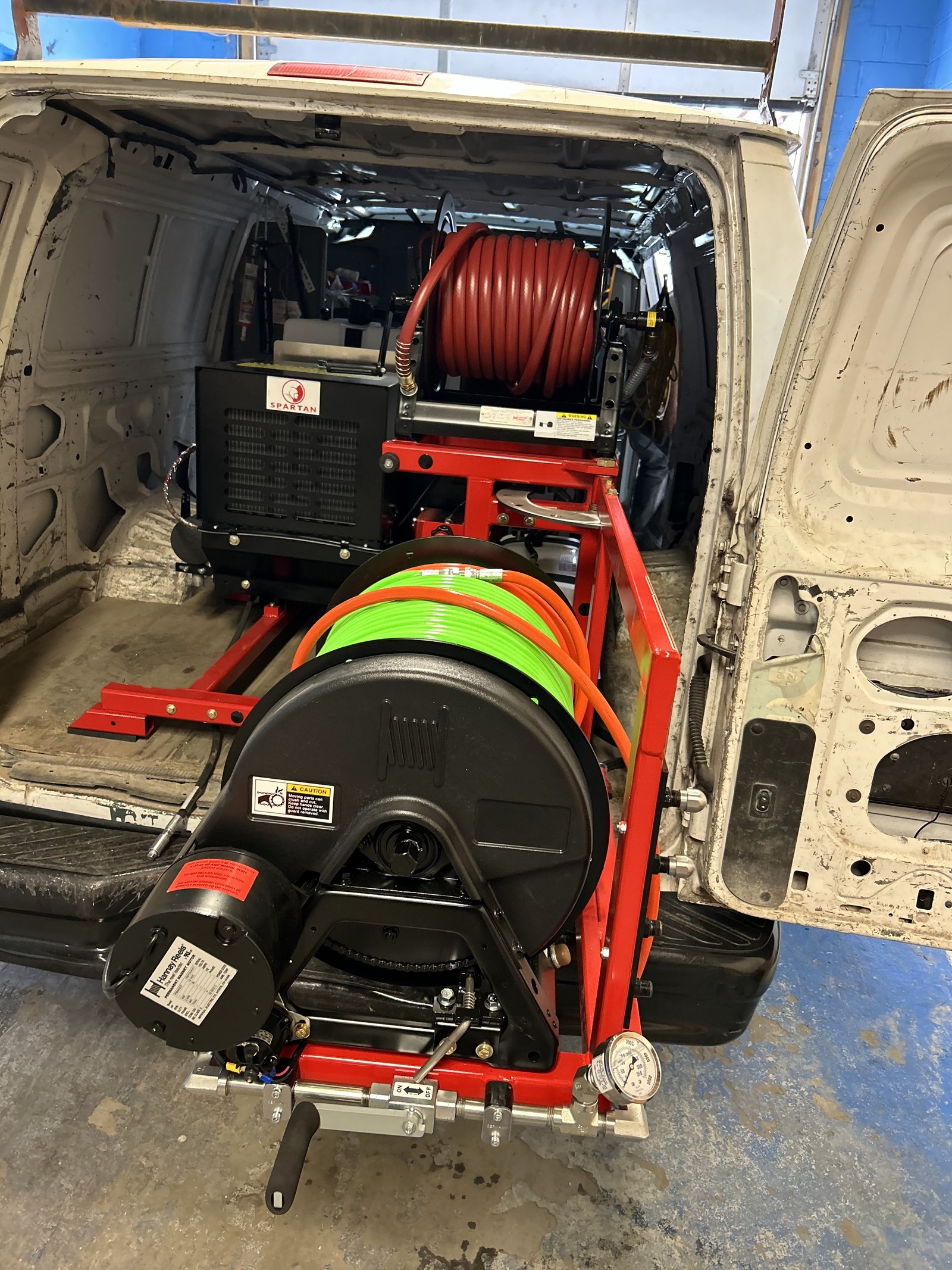 Sewer cleaning equipment mounted inside a service van