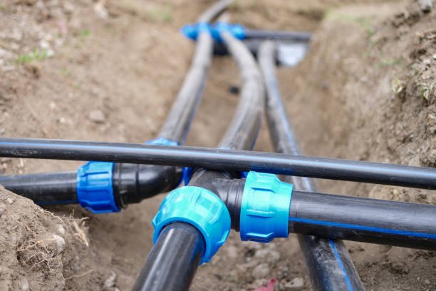 Technicians clearing a root obstruction from a sewer line