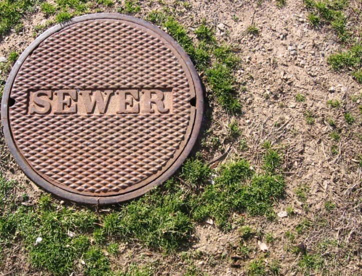 Sewer access cover at a service site